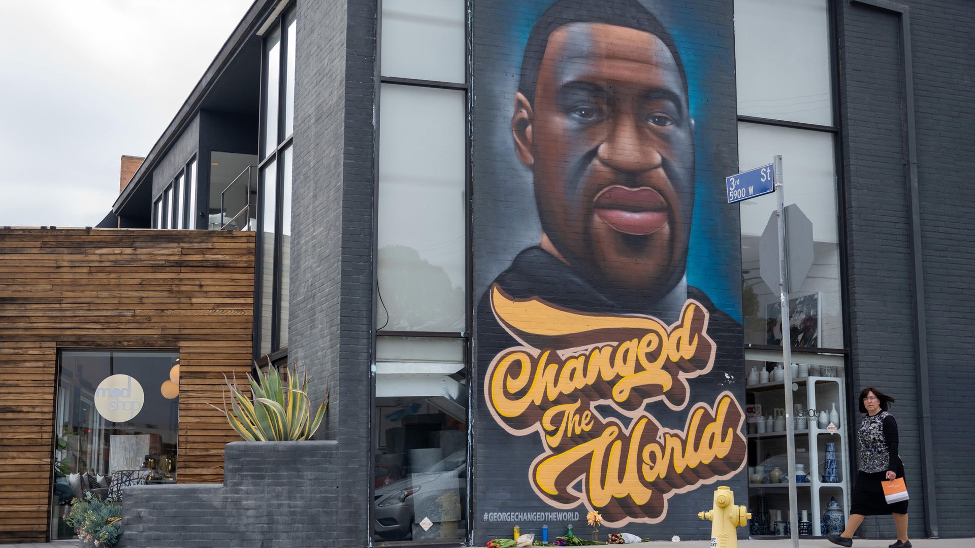 A woman without a mask walks past a mural of George Floyd  on April 21, 2021 in Los Angeles, California - Credit: Photo by Alexi Rosenfeld/Getty Images