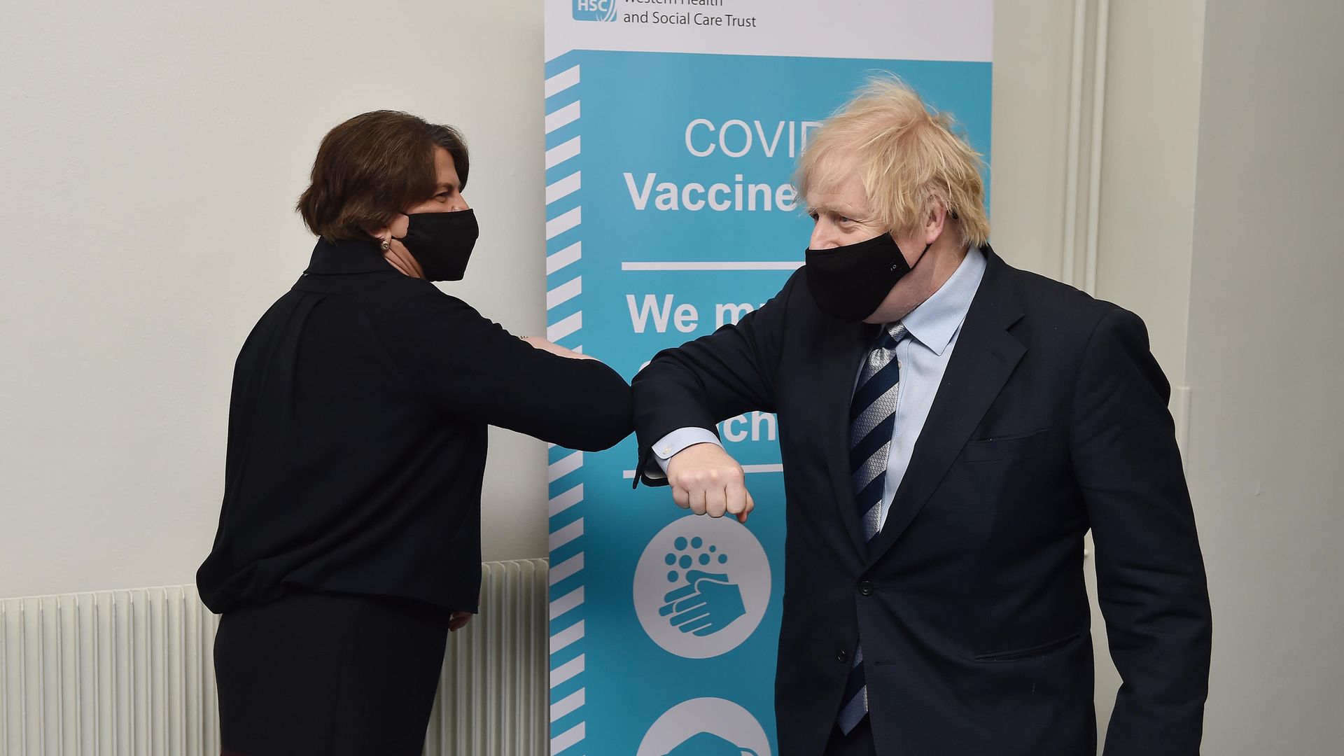 Prime Minister Boris Johnson is greeted with an elbow bump by First Minister Arlene Foster during a visit to Northern Ireland - Credit: PA