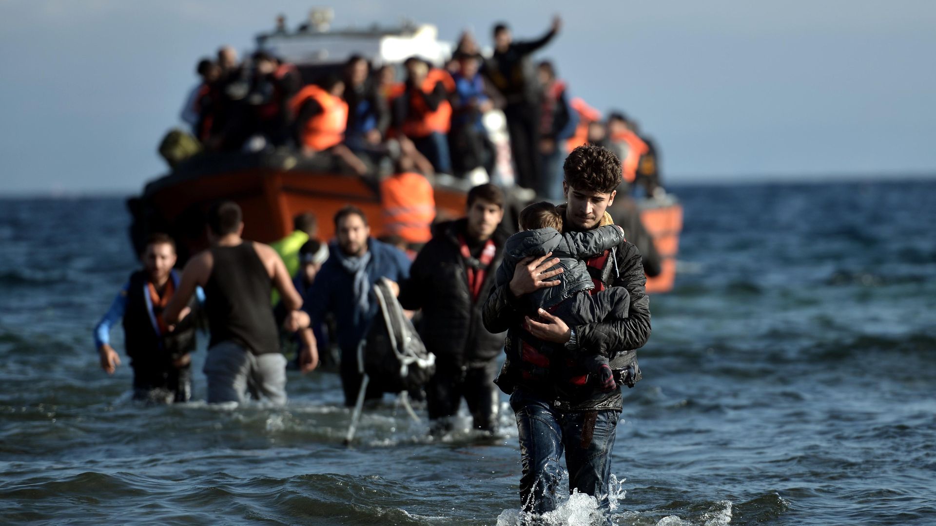 Migrants arrive on the Greek island of Lesbos after crossing the Aegean Sea from Turkey in 2015 - Credit: AFP via Getty Images