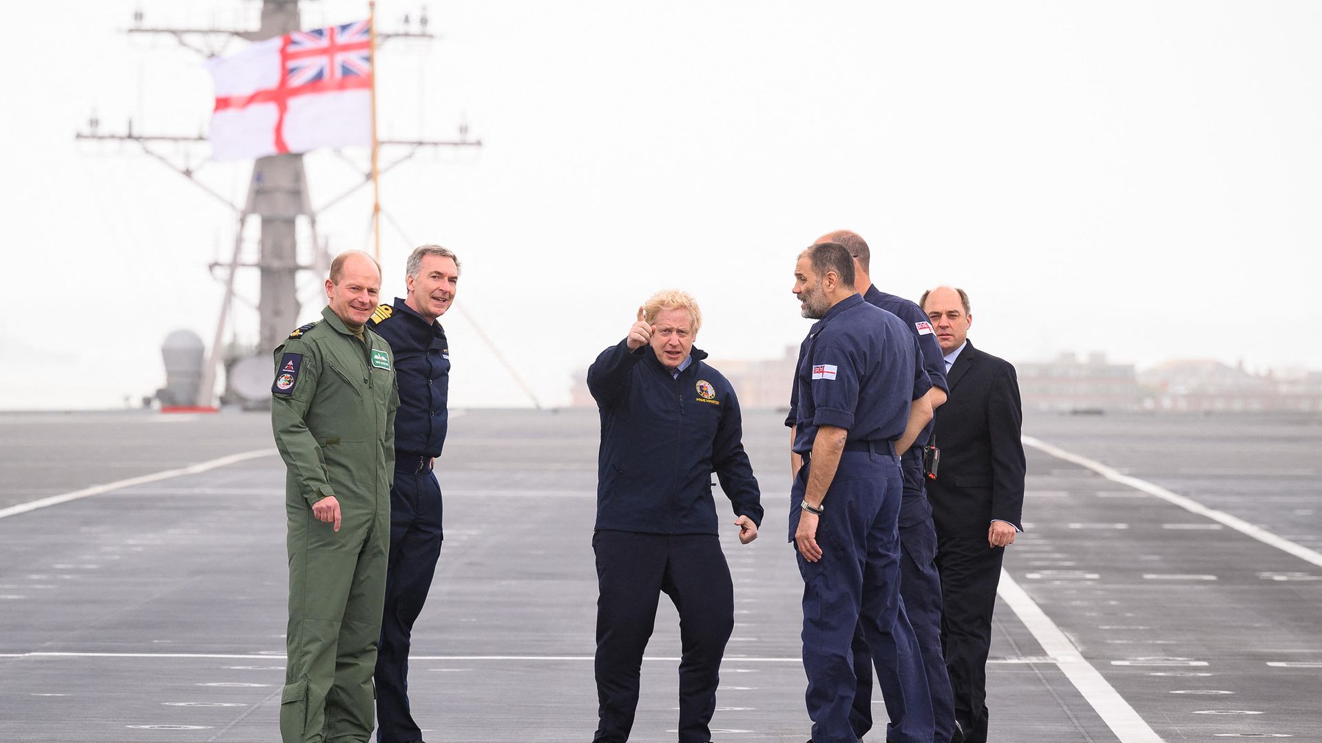 Boris Johnson gestures as he stands on the flight deck during a visit to HMS Queen Elizabeth aircraft carrier in Portsmouth - Credit: POOL/AFP via Getty Images