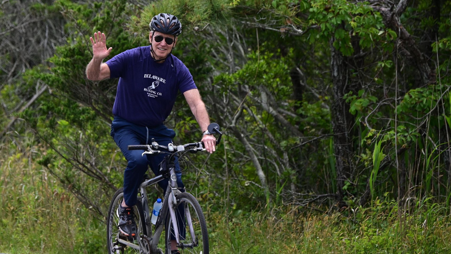 Joe Biden riding his bicycle in Cape Henlopen State Park on June 3, 2021, in Lewes, Delaware - Credit: AFP via Getty Images