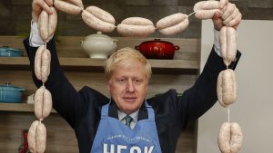 Boris Johnson holds up a string of sausages during his campaign for the Tory leadership. Credit: PA