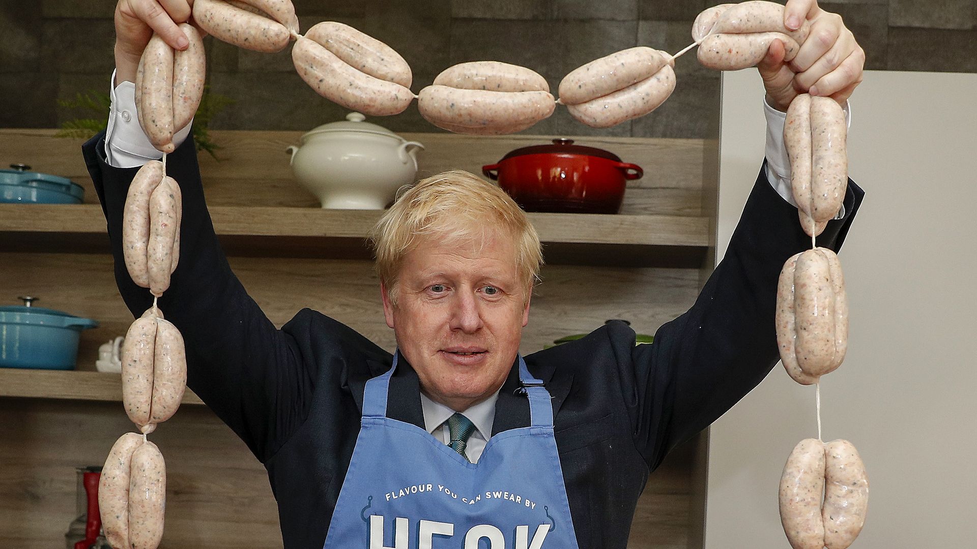 Boris Johnson holds up a string of sausages during his campaign for the Tory leadership. Credit: PA