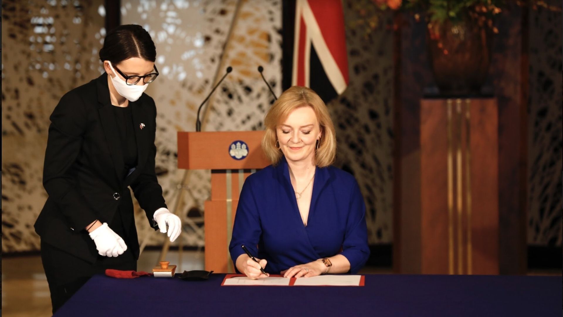 Liz Truss signing a trade deal - Credit: PA