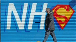 A man walks past a sign created in support of the NHS during the pandemic. Photo: Peter Byrne/PA