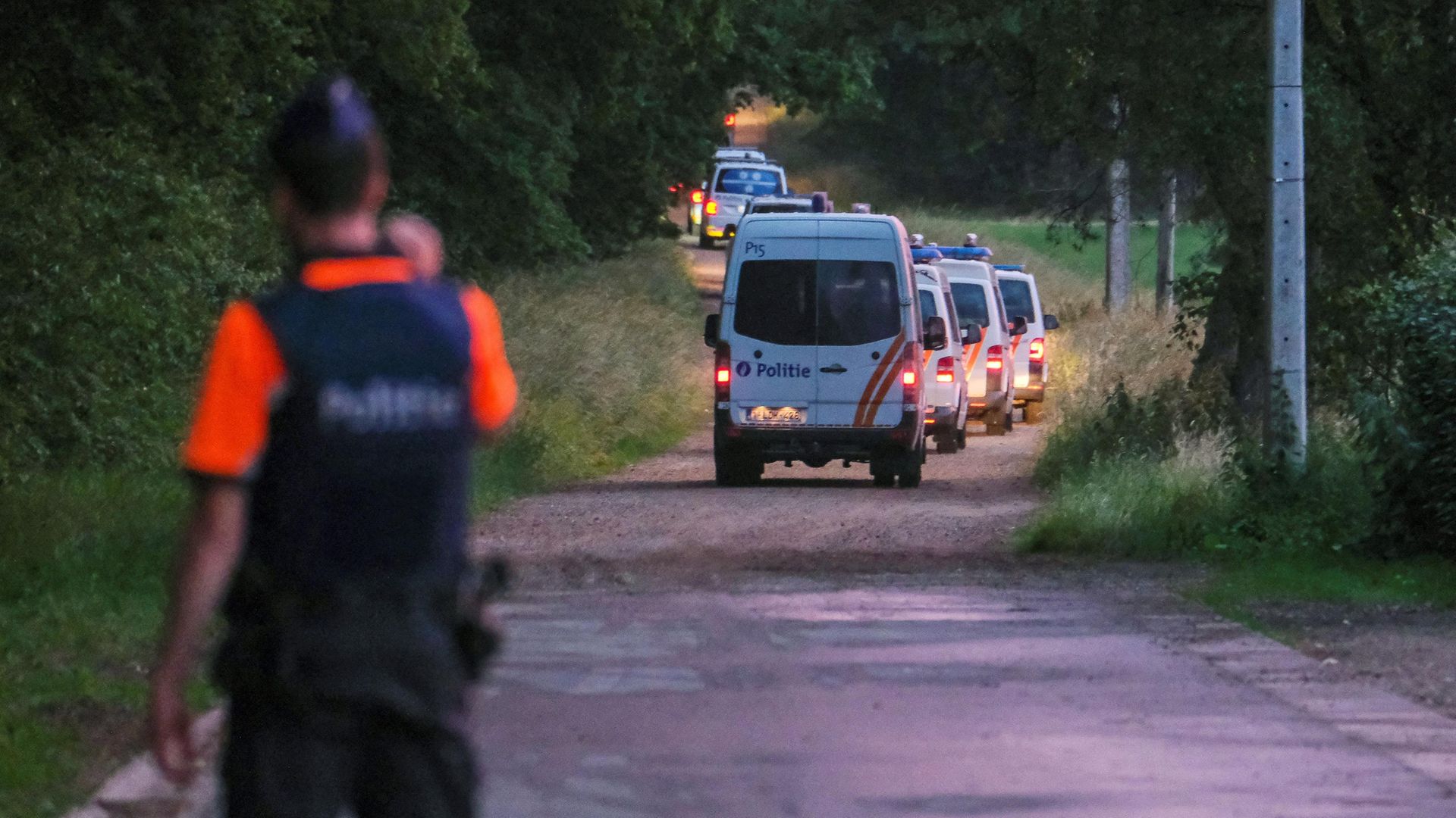 Police vehicles arrive near the spot where the body of Jurgen Conings was found in the Dilserbos forest area of eastern Belgium - Credit: BELGA/AFP via Getty Images