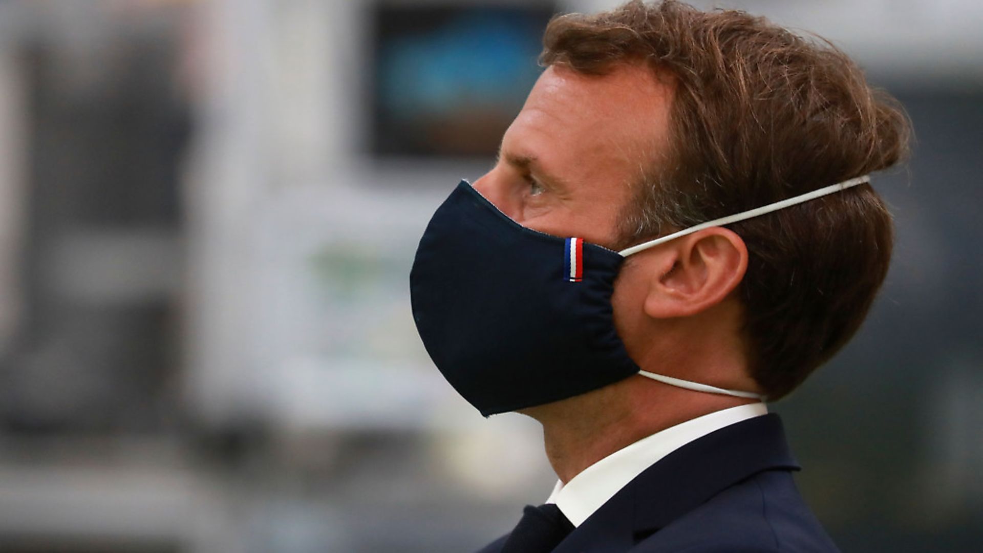 French President Emmanuel Macron, wearing a protective face mask, looks on as he visits a factory of manufacturer Valeo in Etaples, near Le Touquet, northern France. Photo: Getty Images - Credit: POOL/AFP via Getty Images