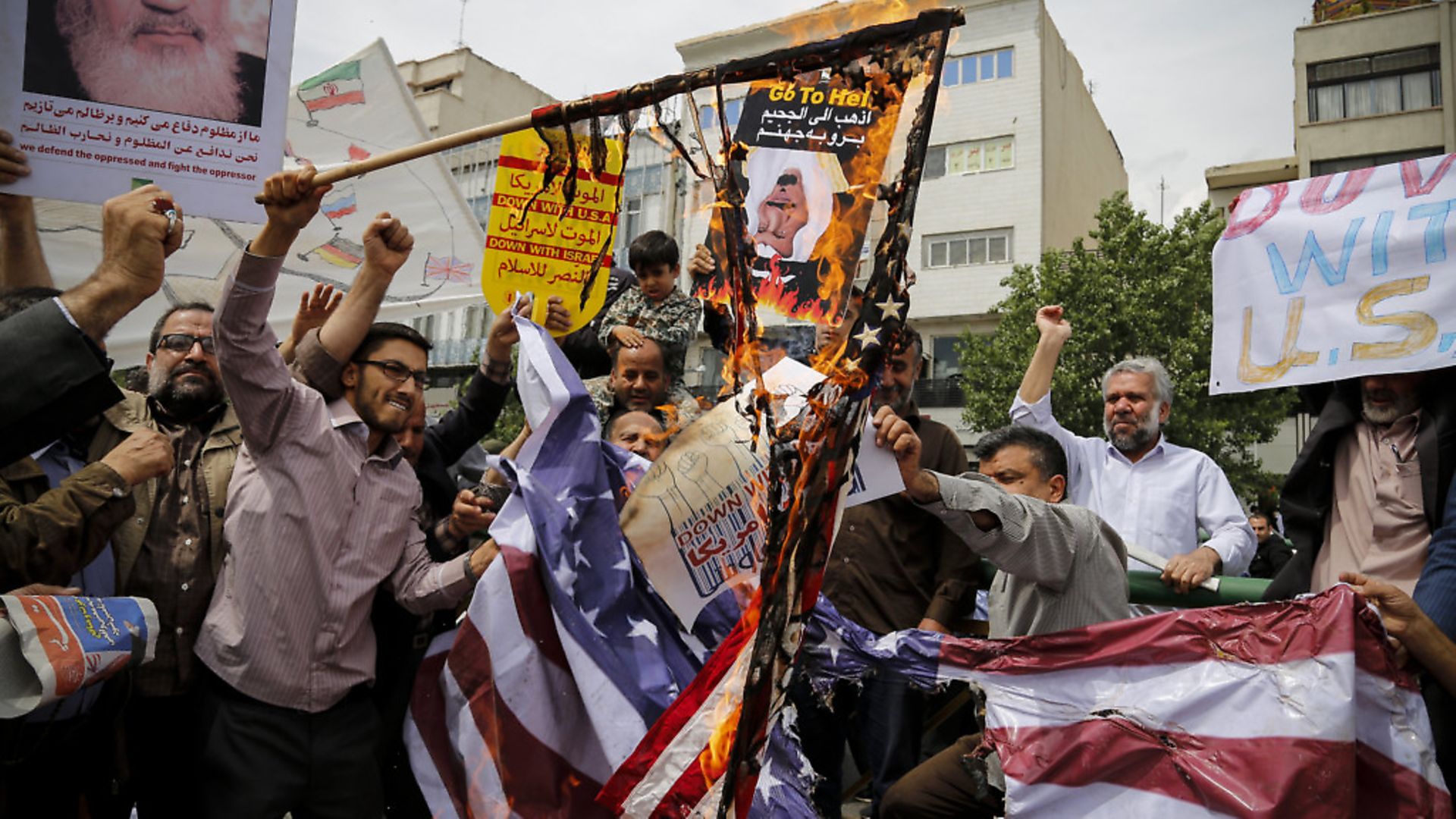 Iranian demonstrators burn American flags during a protest in Tehran, Iran on May 11, 2018, following the decision by U.S. President Donald Trump to pull out of the nuclear deal and renew sanctions on the country. - Credit: PA Images