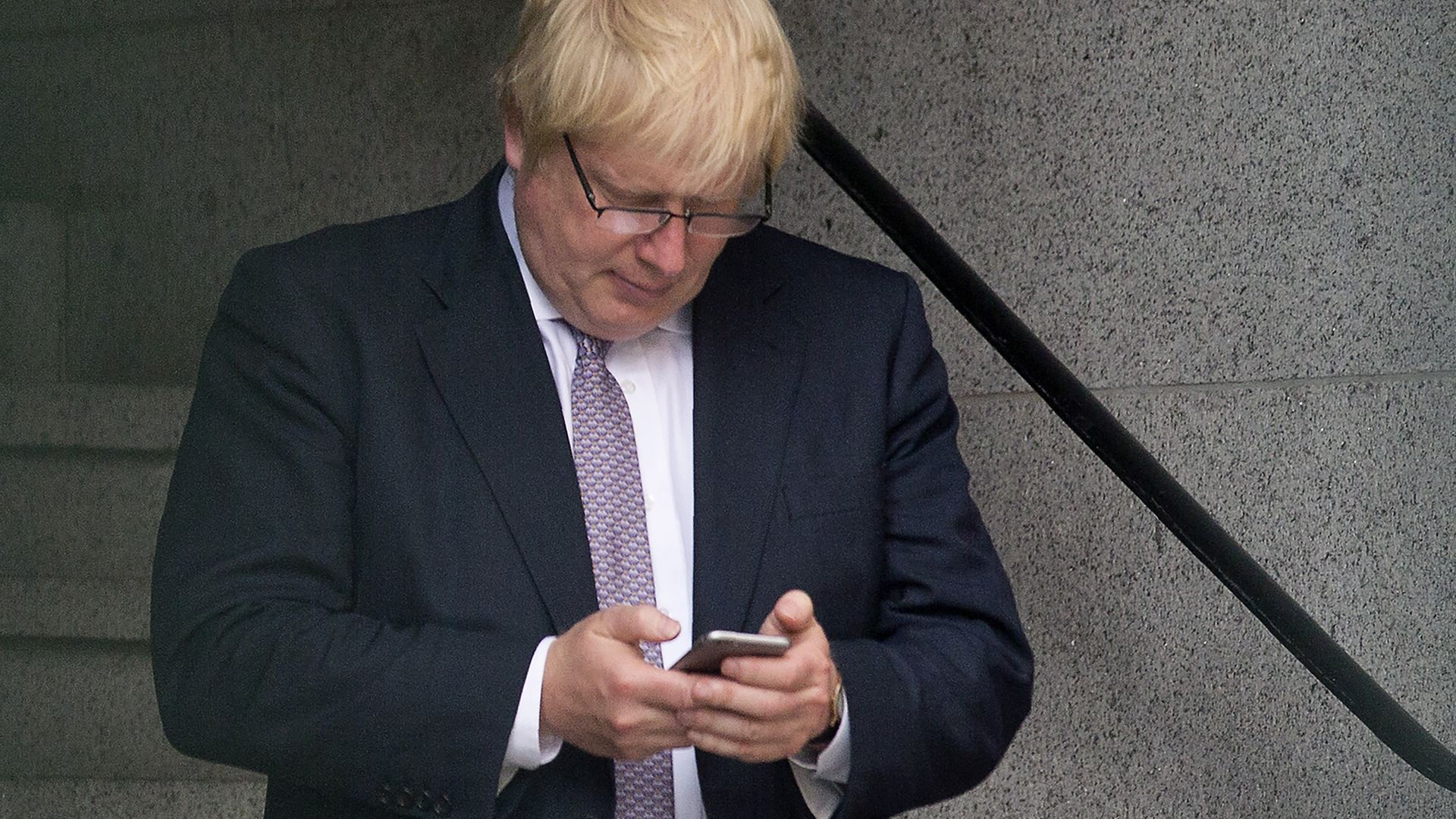 Boris Johnson on a mobile phone, June 2016 - Credit: Photo by JUSTIN TALLIS/AFP via Getty Images