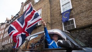 A London taxi driver waves a Union Jack flag in Westminster after the Brexit vote. Photo: PA.