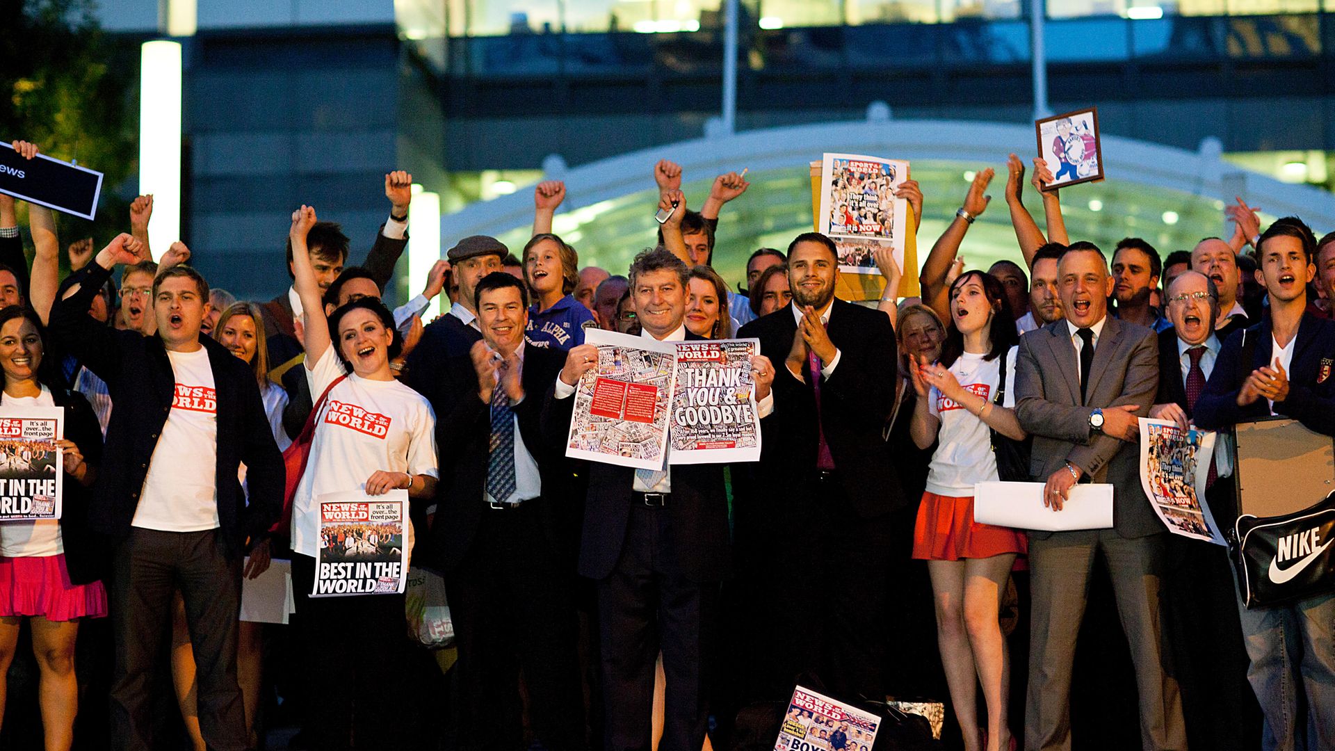 Staff of the News of the World Editor, with editor Colin Myler in the centre, hold up copies of the last ever edition of the paper, in July 2011 - Credit: Getty Images