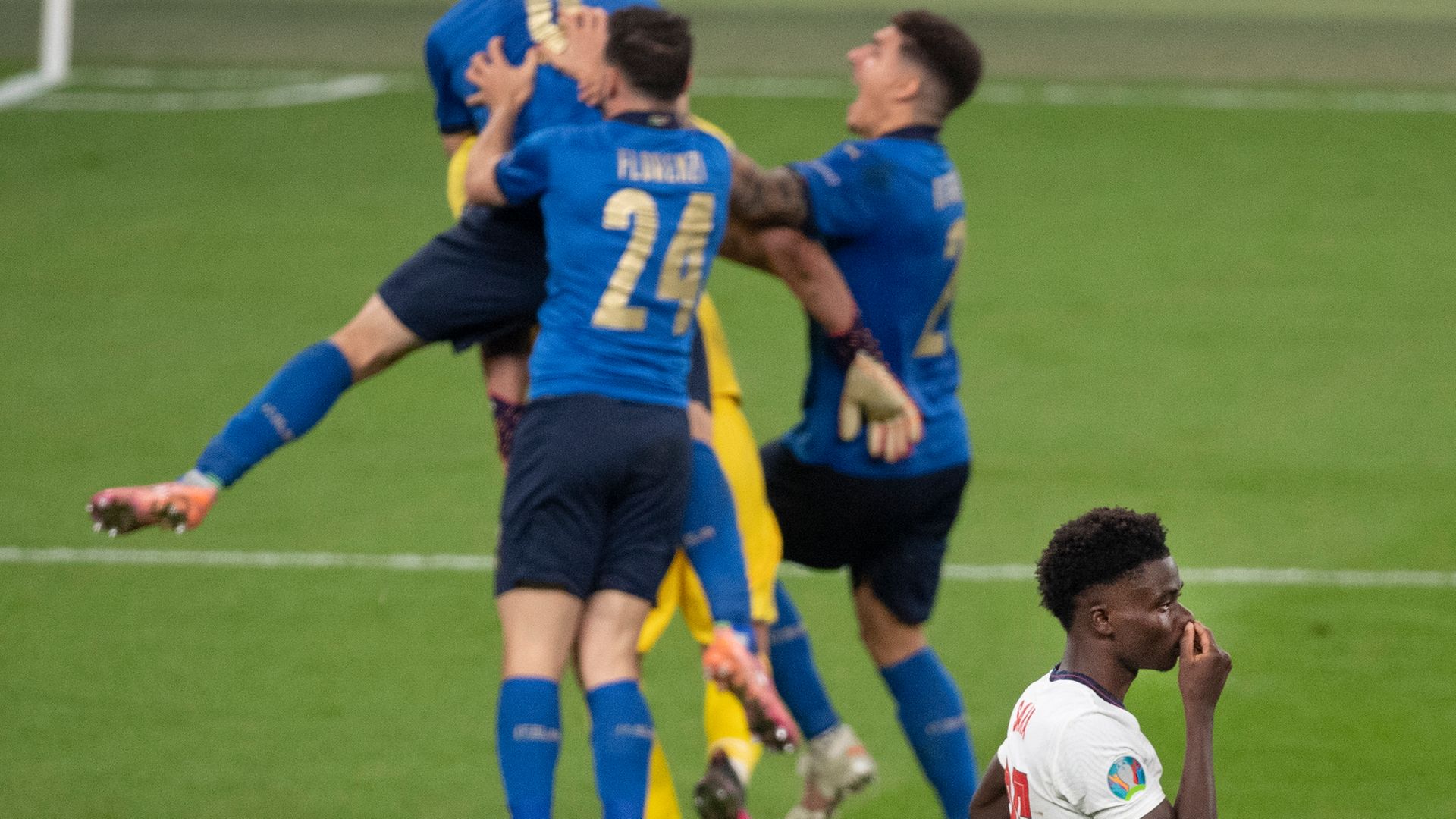 Italy celebrate in front of Bukayo Saka of England after he misses the crucial penalty of the shootout in the UEFA Euro 2020 Championship final - Credit: Photo by Visionhaus/Getty Images