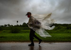 A man walks through the rain in Batabano, Mayabeque province as Hurricane Ida passes through eastern Cuba. Photo: Getty Images.