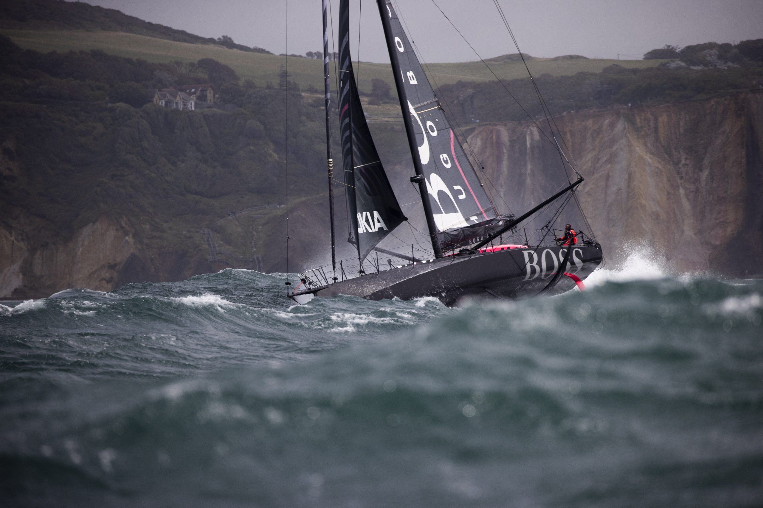 A yacht taking part in the Fastnet Race battles stormy seas near the start line off the Isle of Wight. 