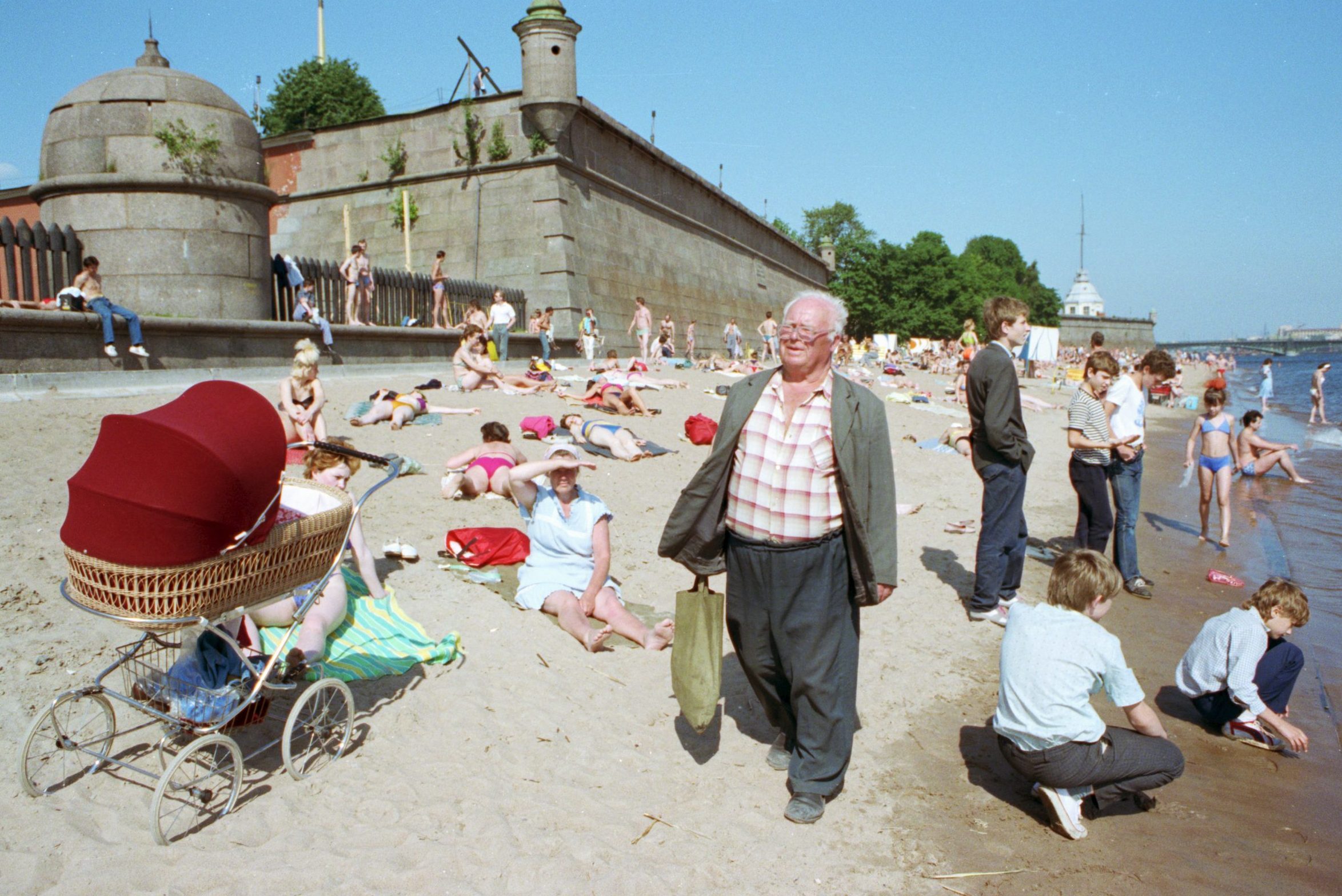 Before the fall... Russians sunbathe on the beach on the Neva River, Leningrad, in the summer of 1991, just weeks before the events that brought down the USSR