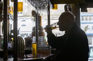 A customer at the Waverley, Edinburgh, enjoys a drink at the bar. Alcohol can now be served inside pubs and restaurants, which are allowed to stay open until 22.30, as Scotland moves to Level 2 restrictions to ease out of lockdown. Credit: Jane Barlow/PA Wire/PA Images