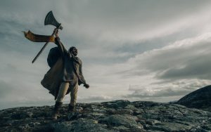 A scene from the delayed
movie version of The Green
Knight, starring Dev Patel
Credit: Eric Zachanowich/ Courtesy A24