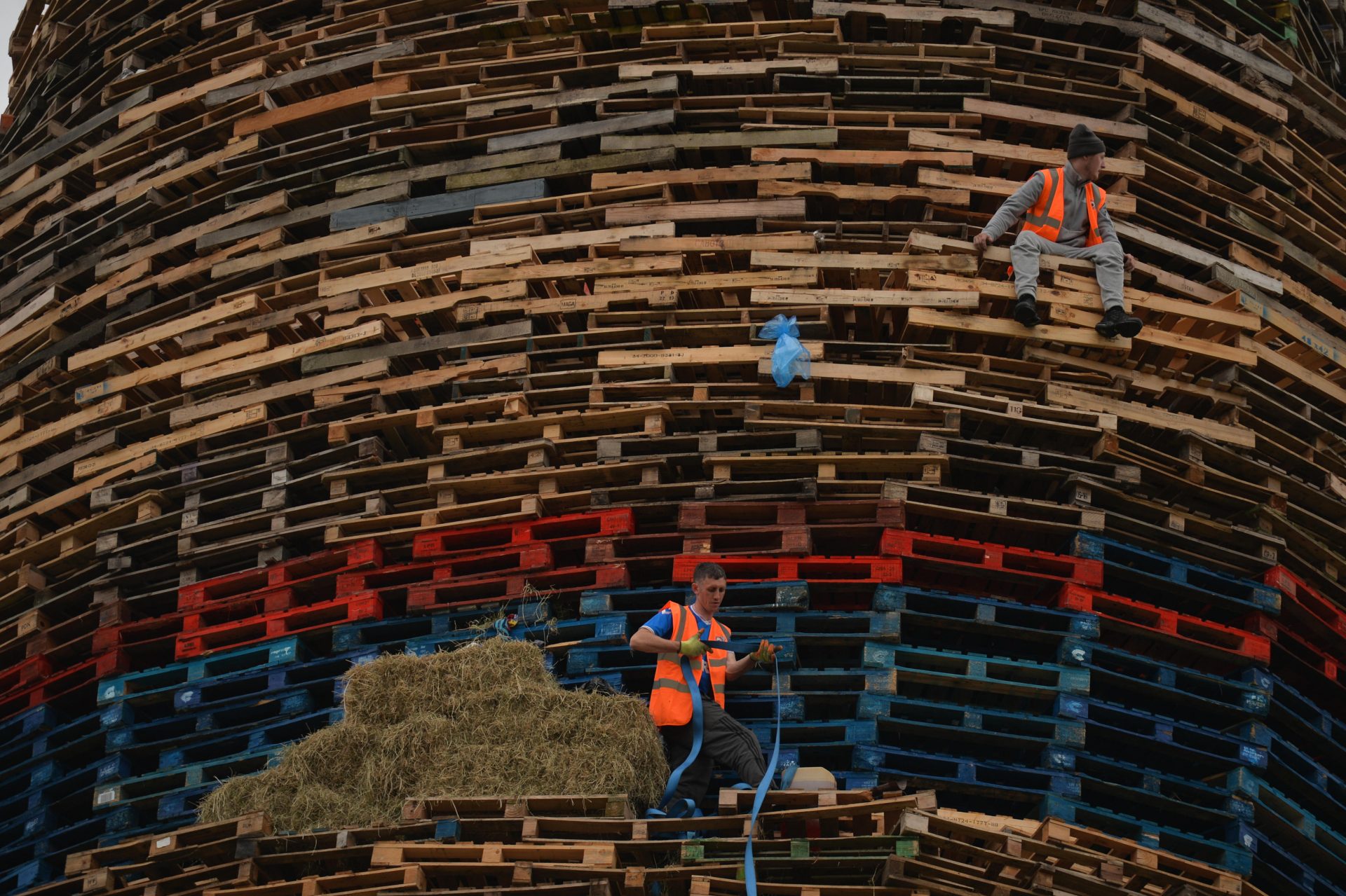 Bonfire builders in Craigy Hill, Larne, ahead of Protestant ‘Twelfth’ celebrations this summer, which saw large gatherings. This bonfire consisted of 17,000 pallets and was 45m high. Photo: NurPhoto via Getty Images.