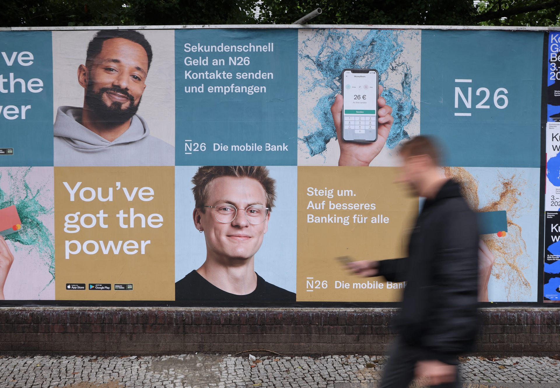 A man with a smartphone walks past a billboard advertising German internet bank N26 in Berlin, Germany (Photo by Sean Gallup/Getty Images)