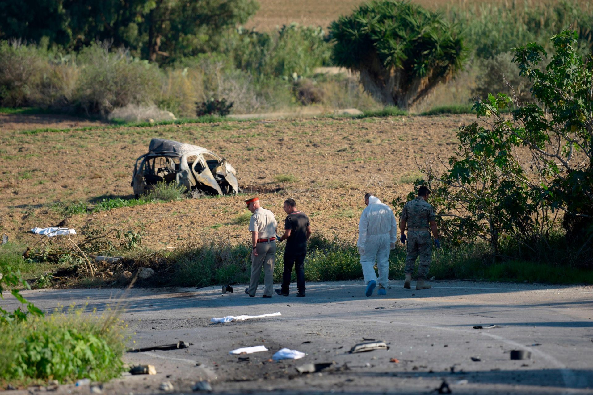 Police and forensic experts inspect the wreckage of a car bomb which killed journalist Daphne Caruana Galizia in Malta, in 2017. One man has been jailed for her murder, which has been linked to a wider conspiracy involving senior Maltese establishment figures. Photo: STR/AFP via Getty Images