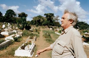 Henning Mankell in a cemetery in
Maputo, where he worked as an Aids
activist. At the time, 50 people were
being buried at the site each day and
due to the lack of space new graves
were being dug amidst the old ones. Credit: Gideon Mendel/Corbis via Getty