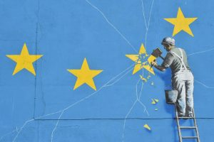 A 2017 mural by Banksy in Dover, depicting a workman chipping away at one of the stars on the European flag. Photo: Glyn Kirk/Getty Images.