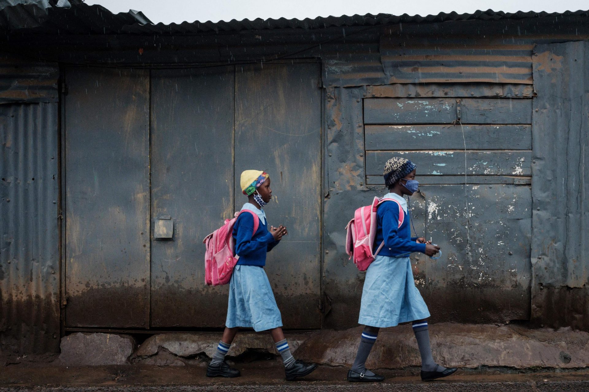 Pupils walk to school in Kibera slum, Nairobi, after a lengthy closure due to Covid-19. For most pupils, a whole year of school was cancelled. Photo: Yasuyoshi Chiba/AFP via Getty Images.