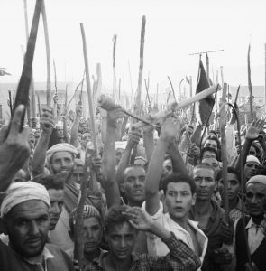 Protesters in Khenifra, French Morocco, wave weapons during an uprising against the French government in 1955. The struggle for independence forms the backdrop of Paul Bowles’ novel The Spider House. Photo: Bettmann Archive/Getty.