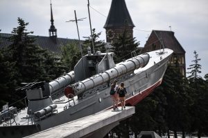 Children walk next to a memorial featuring a Soviet torpedo boat from the Second World War in Kaliningrad. Photo: Ozan Kose/AFP/Getty Images
