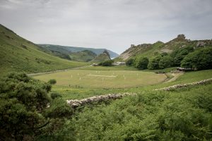 Match play on the pitch during an annual friendly match between Cravens Cavaliers and Lynton & Lynmouth Cricket Club at their ground based inside the Valley of Rocks, North Devon. Credit:  Ben Birchall/PA Archive/PA Images