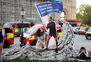 A demonstrator with an installation depicting Facebook founder Mark Zuckerberg during a protest opposite Parliament. Photo: Tolga Akmen/AFP via Getty Images