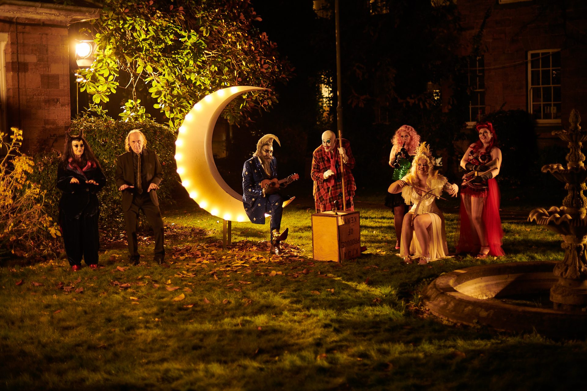 Alan Moore (third left,
sitting on the moon)
dressed for a big night
out in Northampton as
Metterton in The Show. Photo: Altitude Films