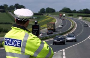 Sgt Paul Moor from Essex Traffic Police uses a laser speed gun on the new stretch of the A130. Photo:  Andrew Parsons/PA Archive/PA Images.