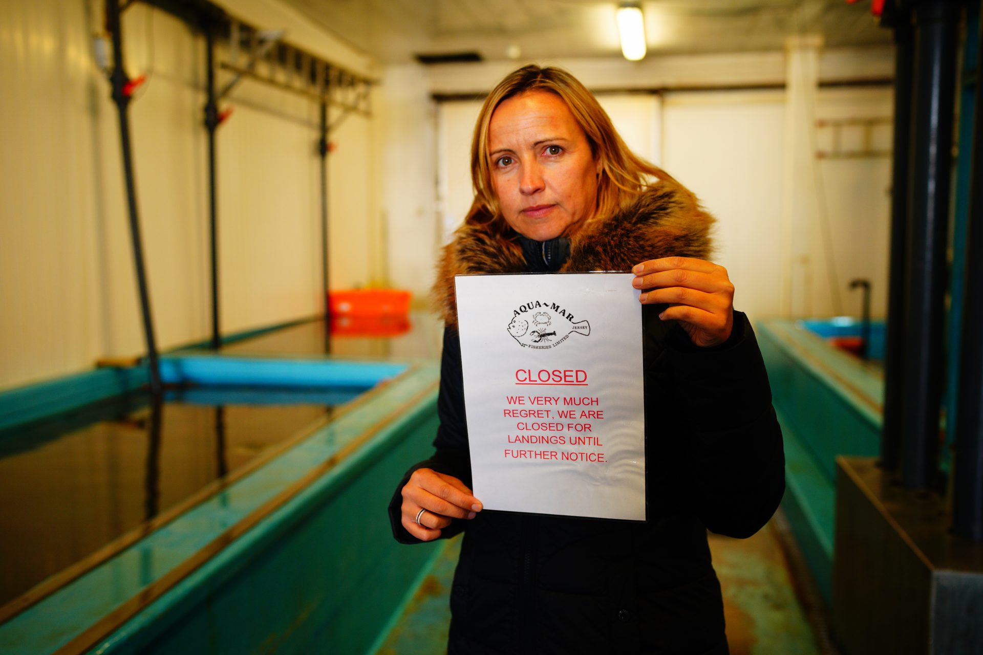 Director of Aqua Mar fisheries in Jersey, Nathalie Porritt, prints a closed sign to let any fishermen know she is winding down trading ahead of political talks as fishermen on the island of Jersey slowly ease off fishing. Photograph:  Ben Birchall/PA Wire/PA Images.