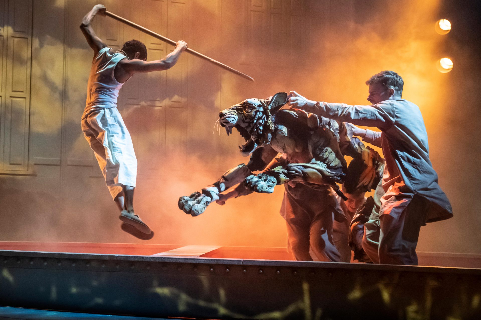 Hiran Abeysekera (Pi) and Tom Larkin (Tiger head) in the astonishing Life of Pi, at the Wyndham’s Theatre. Photo: Johan Persson.