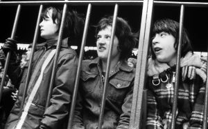 Youngsters watch their heroes from the fenced-in Stretford End at Old Trafford. Photos: Sefton Samuels.