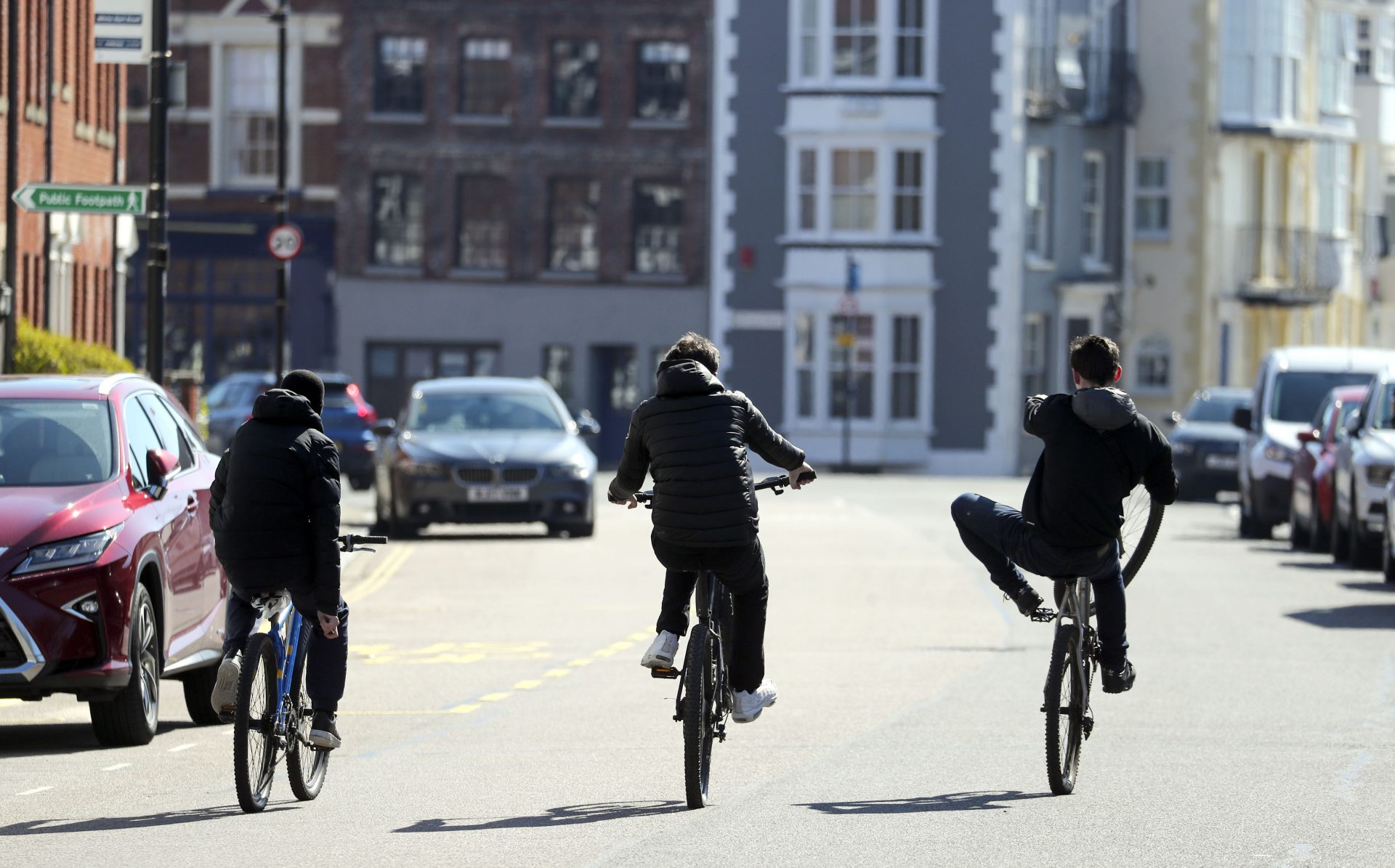 Teenagers ride their bikes down a street in Portsmouth after Prime Minister Boris Johnson has put the UK in lockdown in March 2020. Photo: Steve Parsons/PA Archive/PA Images.