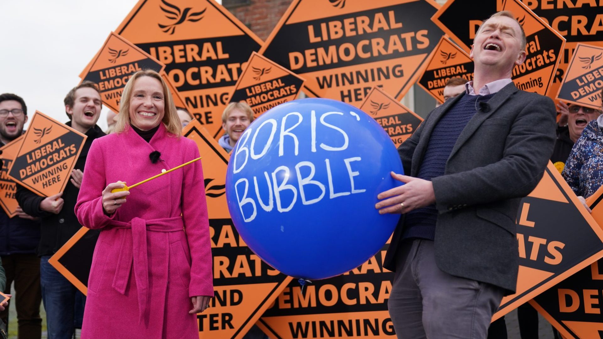 Newly elected Liberal Democrat MP Helen Morgan bursts 'Boris' bubble' held by colleague Tim Farron following her victory in the North Shropshire by-election. Photo:  Jacob King/PA Wire/PA Images.