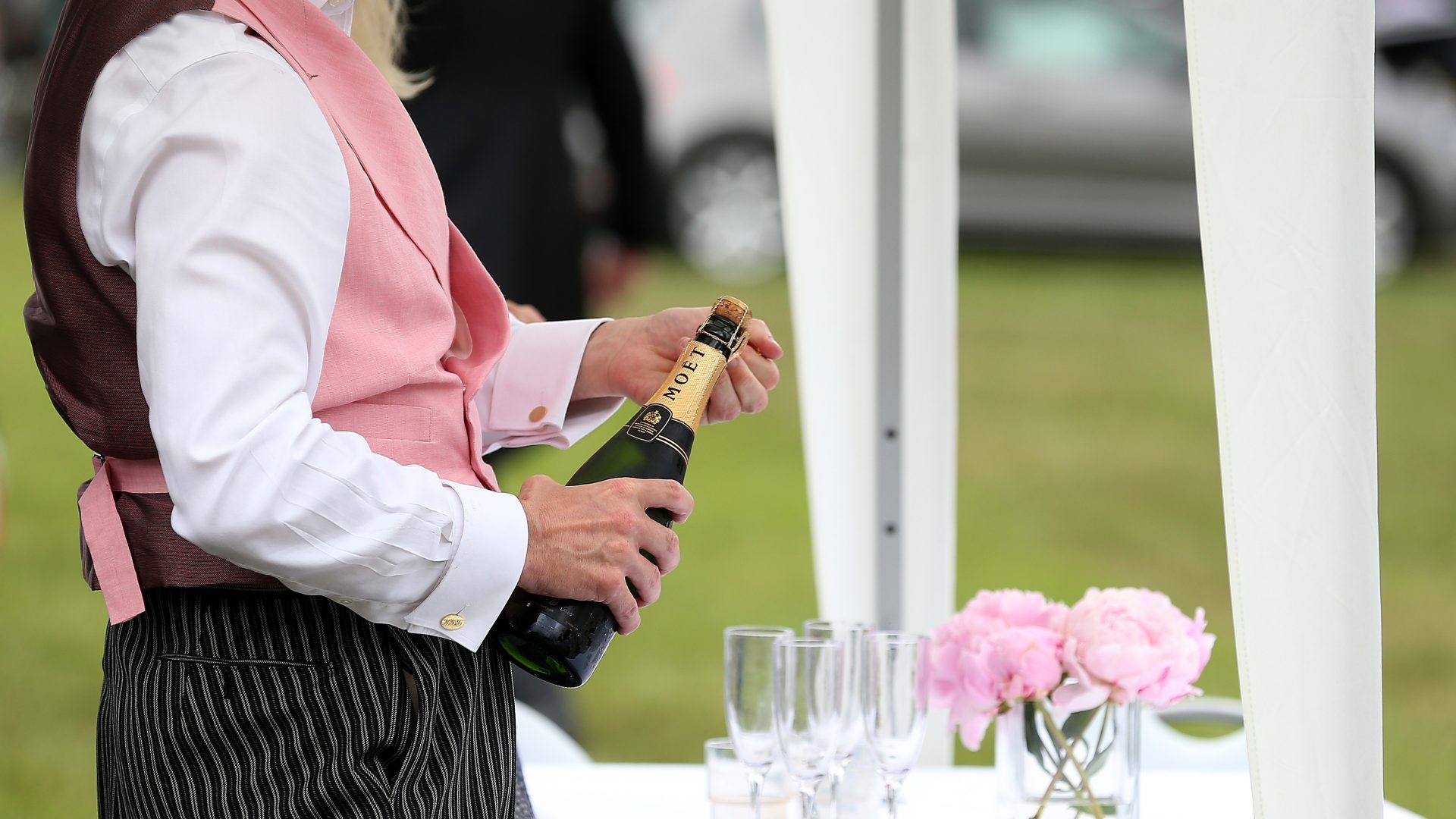 A steward pours glasses of champagne during day two of Royal Ascot at Ascot Racecourse. Photo: Nigel French/PA Archive/PA Images. 