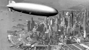 The Nazi Zeppelin Hindenburg cruises over Manhattan in May, 1937, the day before exploding at Lakehurst Naval Air Station, killing 35.
