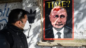 A mural in Rome by street artist Harry Greb depicts a hypothetical Time magazine cover featuring Vladimir Putin with a birthmark in the shape of Ukraine. Photo: Marilla Sicilia/ Mondadori Portfolio/Getty