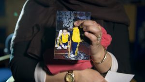 Renu Begum, eldest sister of Shamima Begum, holds her sister's photo. Photo by Laura Lean - WPA Pool/Getty Images