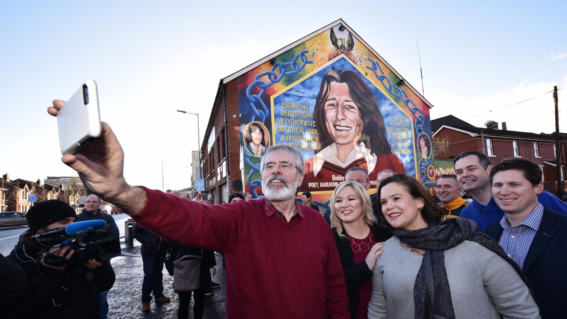 Gerry Adams, left, Michelle O’Neill and Mary Lou McDonald take a selfie in front of the Bobby Sands mural in Belfast, in 2017. Photo: Charles McQuillan/
Getty