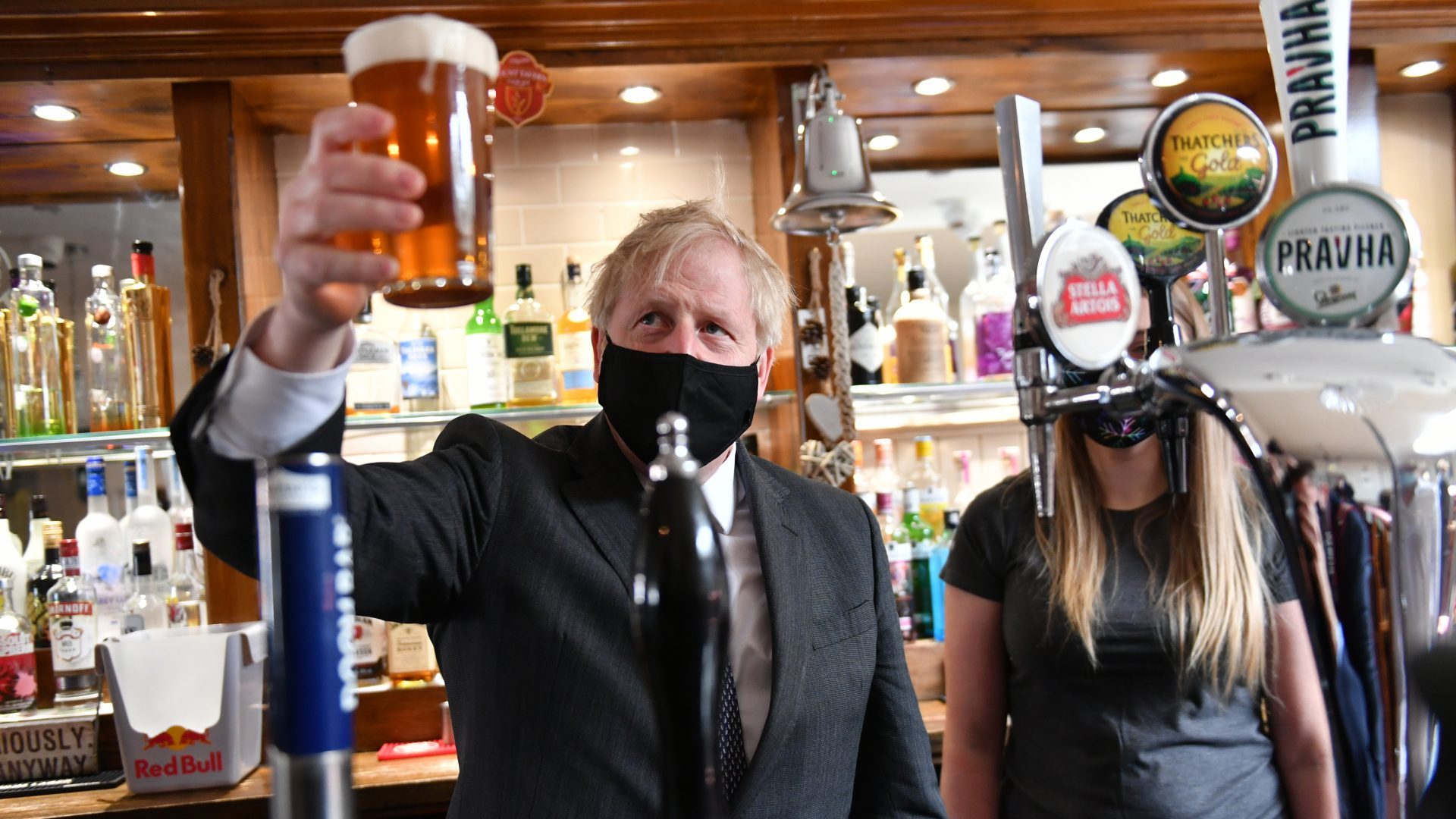 Boris Johnson holds up a pint during a visit to The Mount Taven public house. Photo: Jacob King/PA Archive/PA Images