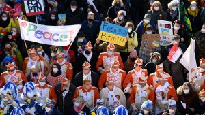 Revellers march with banners for peace and placards in the Ukrainian colors in the center of Cologne. Photo: INA FASSBENDER/AFP via Getty Images