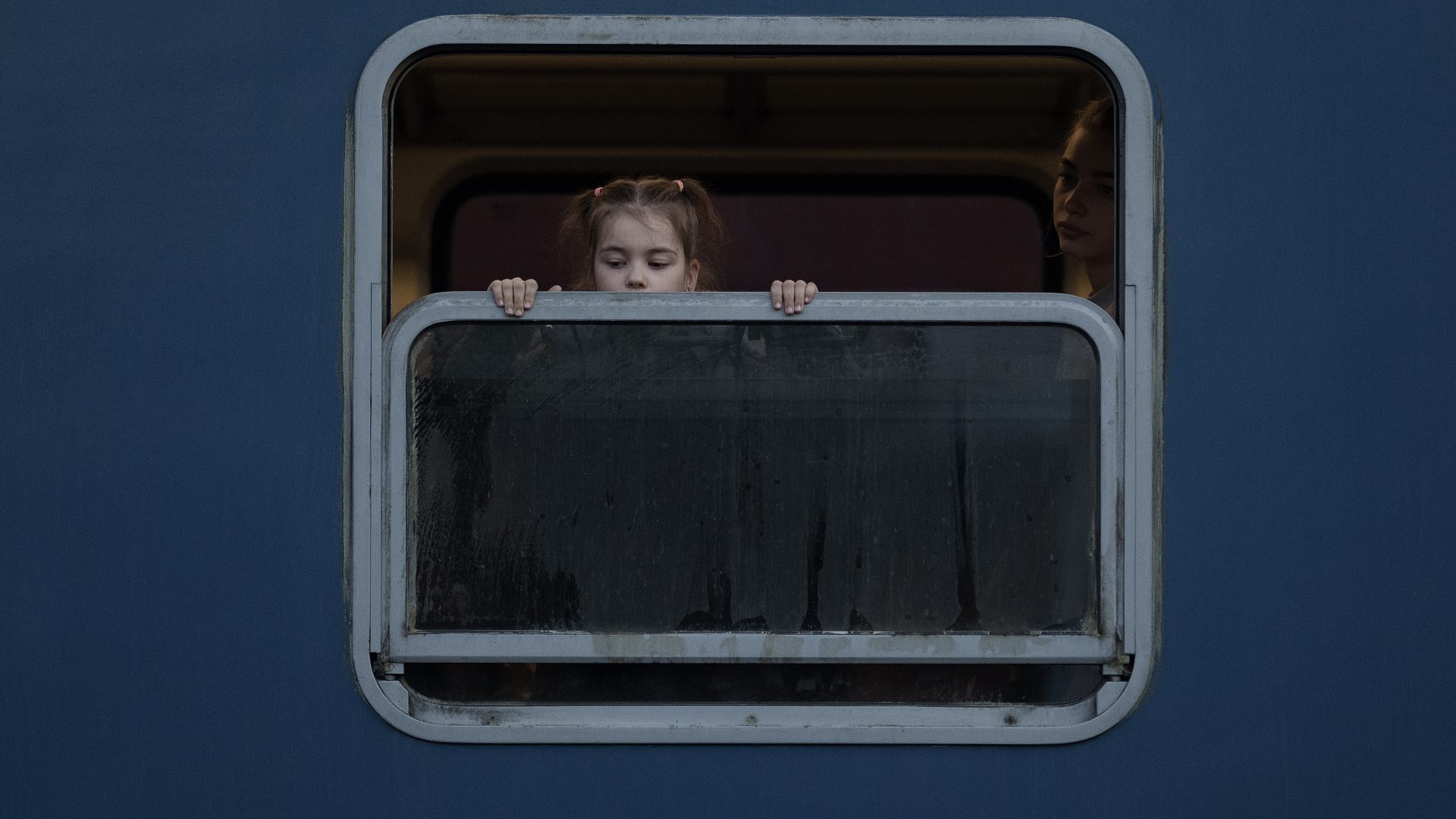 Refugee children fleeing Ukraine look out the window as they arrive into Hungary. Photo:Christopher Furlong/Getty Images