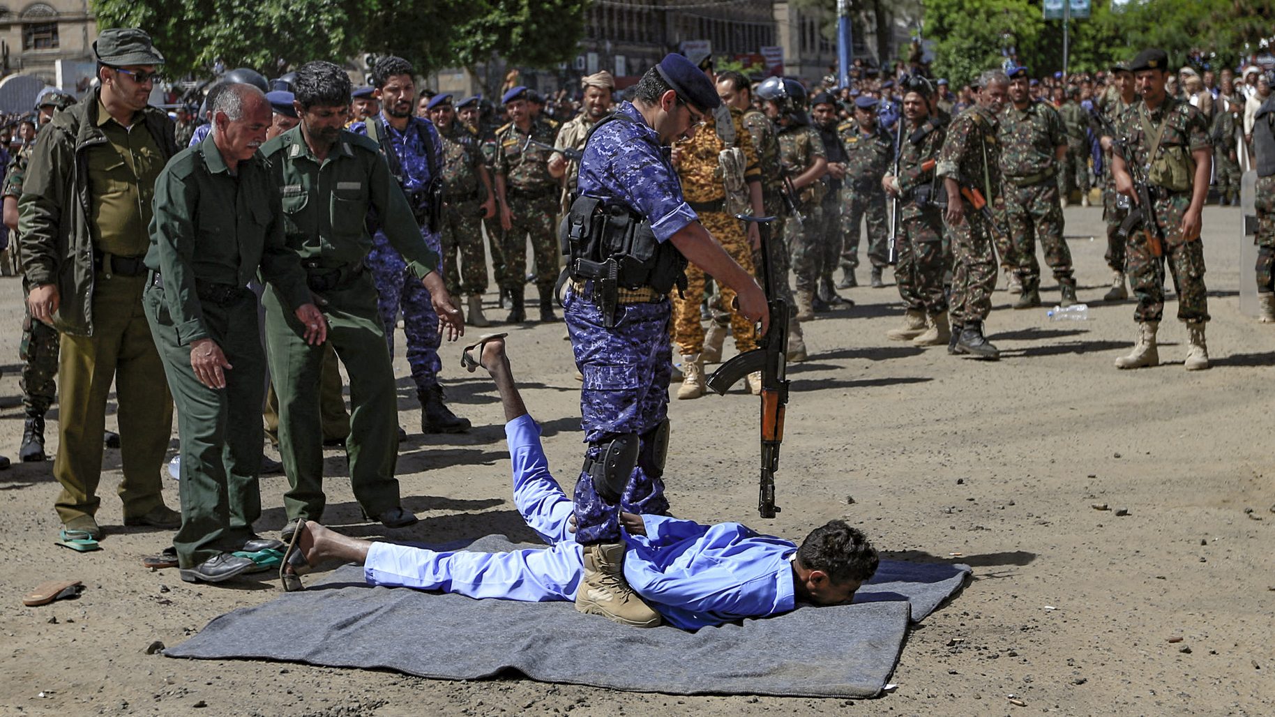 A member of the Yemeni security
forces prepares to execute a man convicted of collaborating with
Saudi Arabia in the assassination of Huthi political leader Saleh al-Sammad. Photo: Mohammed Huwais/AFP