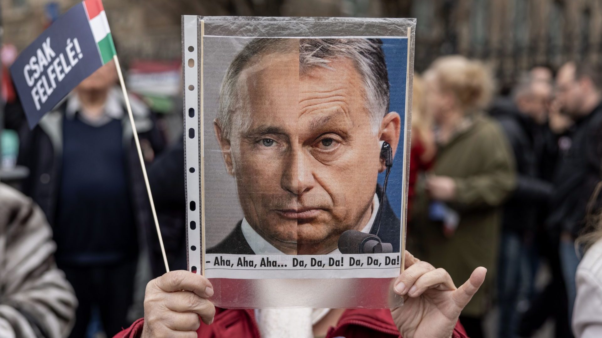 Supporter of the Hungarian prime minister candidate of the Everybody's Hungary Movement, Peter Marki-Zay hold and anti-Orban placard during a demonstration. Photo: Janos Kummer/Getty Images