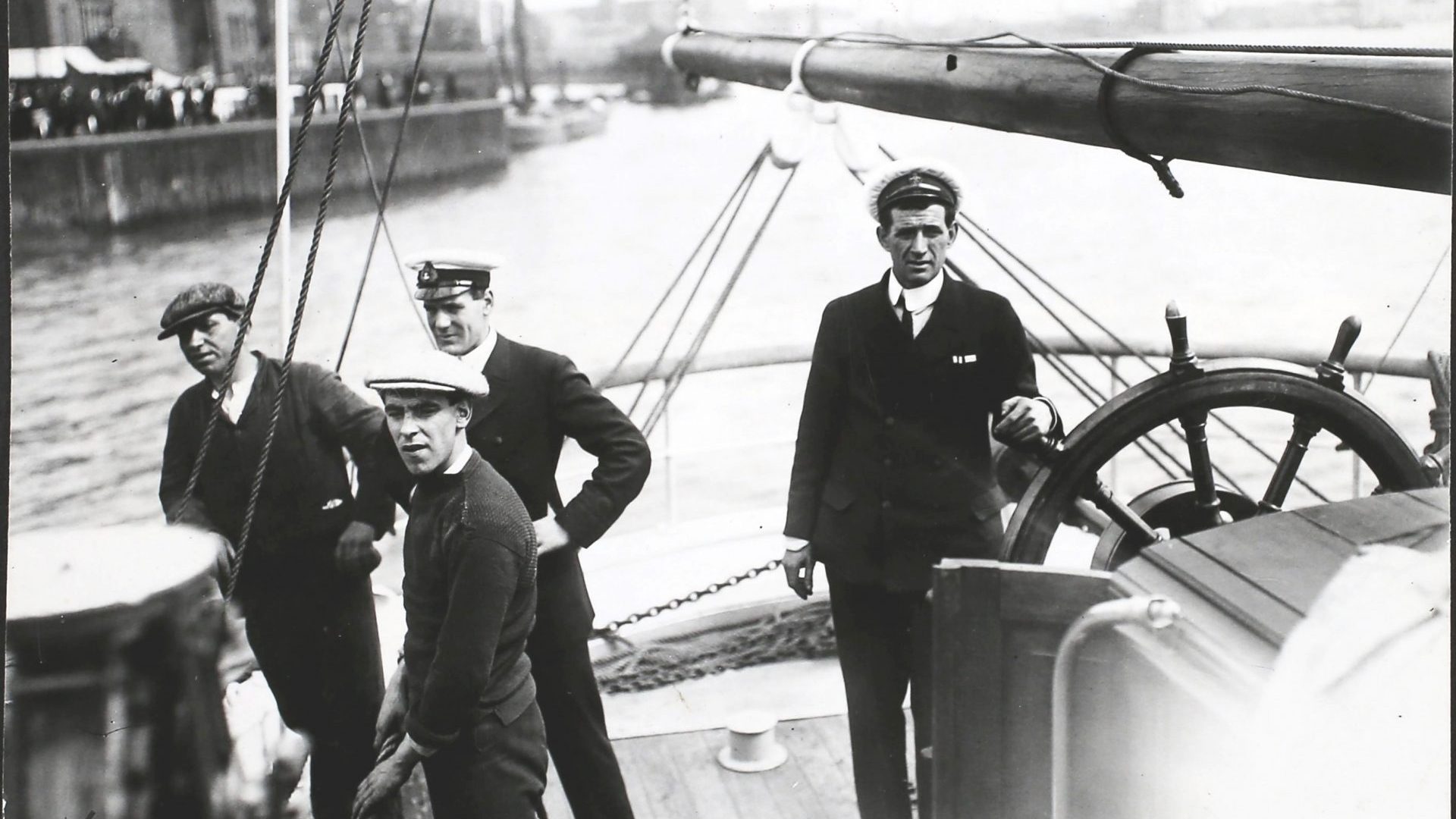 Tom Crean at the helm of the 'Endurance', as she leaves Millwall Dock in London on Ernest Shackleton's Imperial Trans-Antarctic Expedition, 1st August 1914. Photo: Hulton Archive/Getty Images)