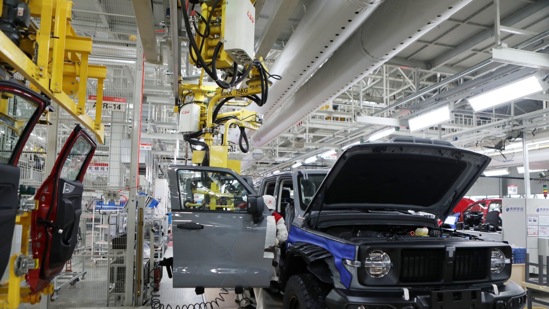 Technicians install the body of a tank 300 at the Final assembly workshop of Great Wall Auto in Chongqing, China (Photo: Costfoto/Future Publishing via Getty Images)